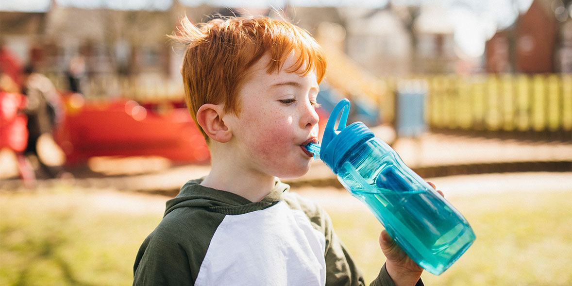 A child drinking from a water bottle